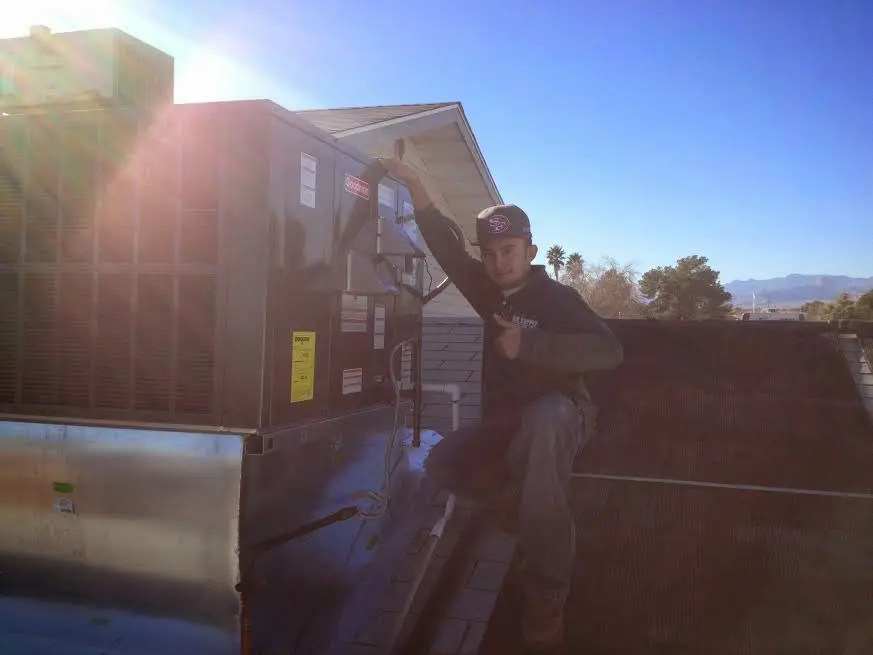 HVAC technician performing AC Tune-Up on a rooftop unit in Antioch